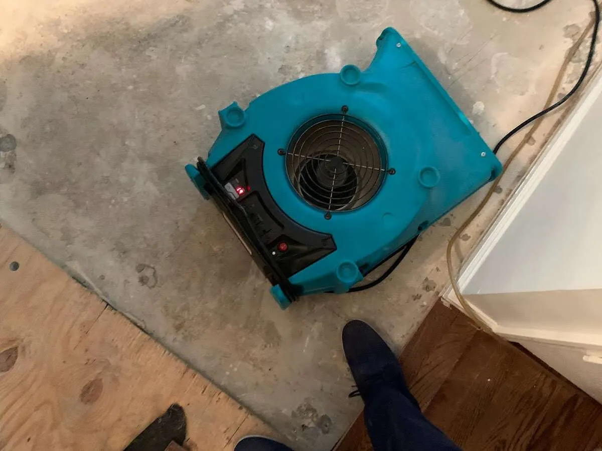 Air mover drying subfloor during Commercial Water Damage Restoration in Round Lake
